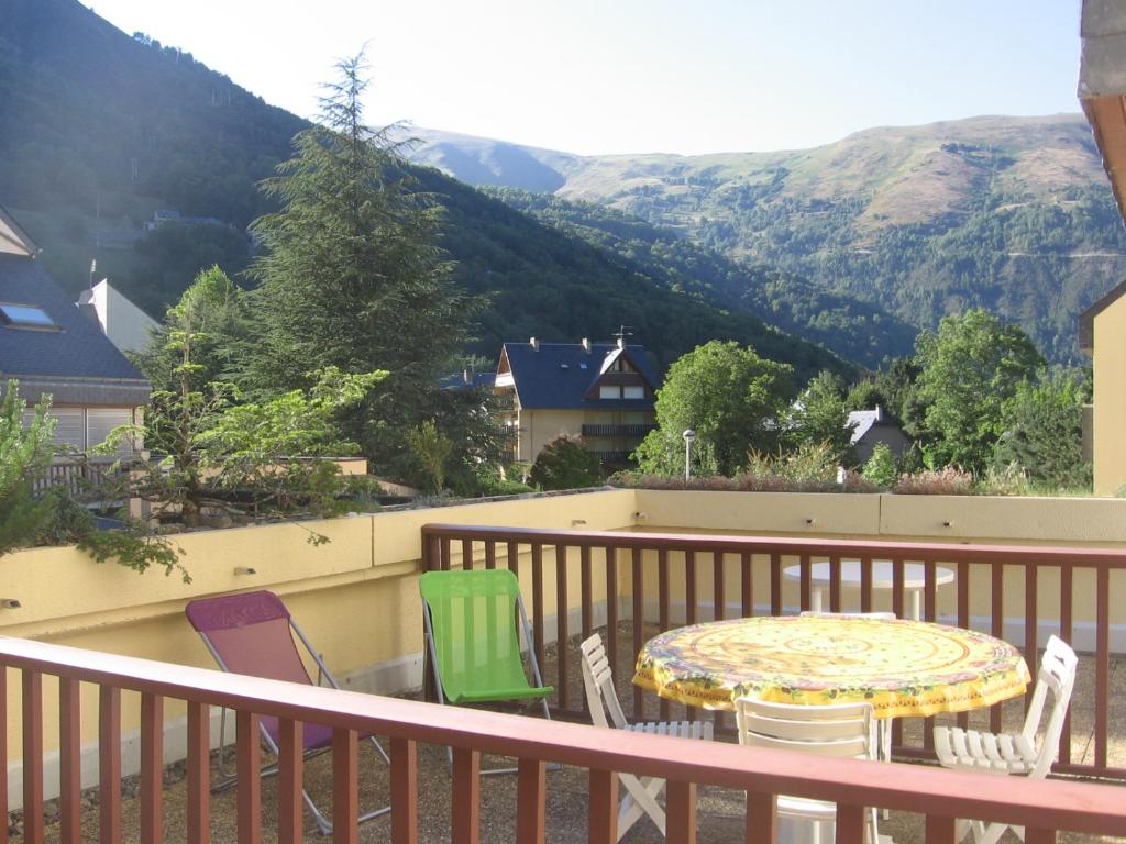 d'une table et de chaises sur un balcon avec vue sur les montagnes. dans l'établissement Très bel appartement, à Saint-Lary-Soulan