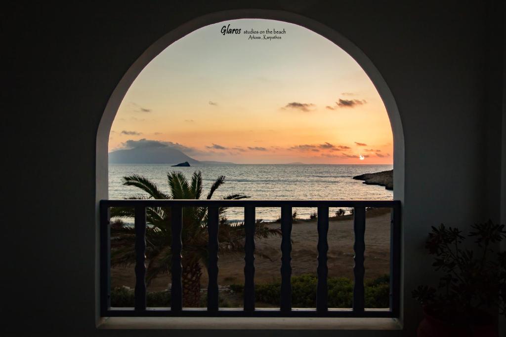 an arched window with a view of the ocean at Glaros luxury studio on the Beach in Arkasa