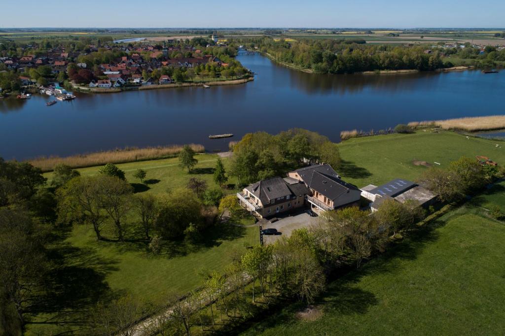 an aerial view of a house next to a lake at Pension Treenehof in Friedrichstadt