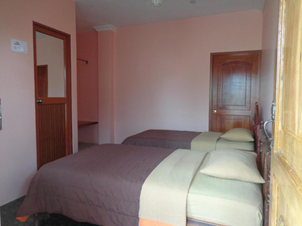Postel nebo postele na pokoji v ubytování Hostal Nathaly