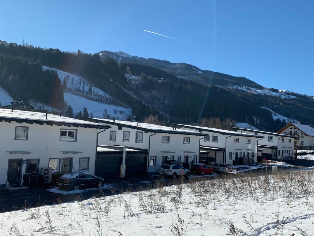 a row of houses in the snow next to a mountain at Haus Schladming in Schladming