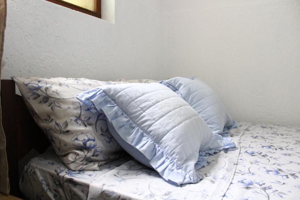 Cama ou camas em um quarto em Baú Pousada