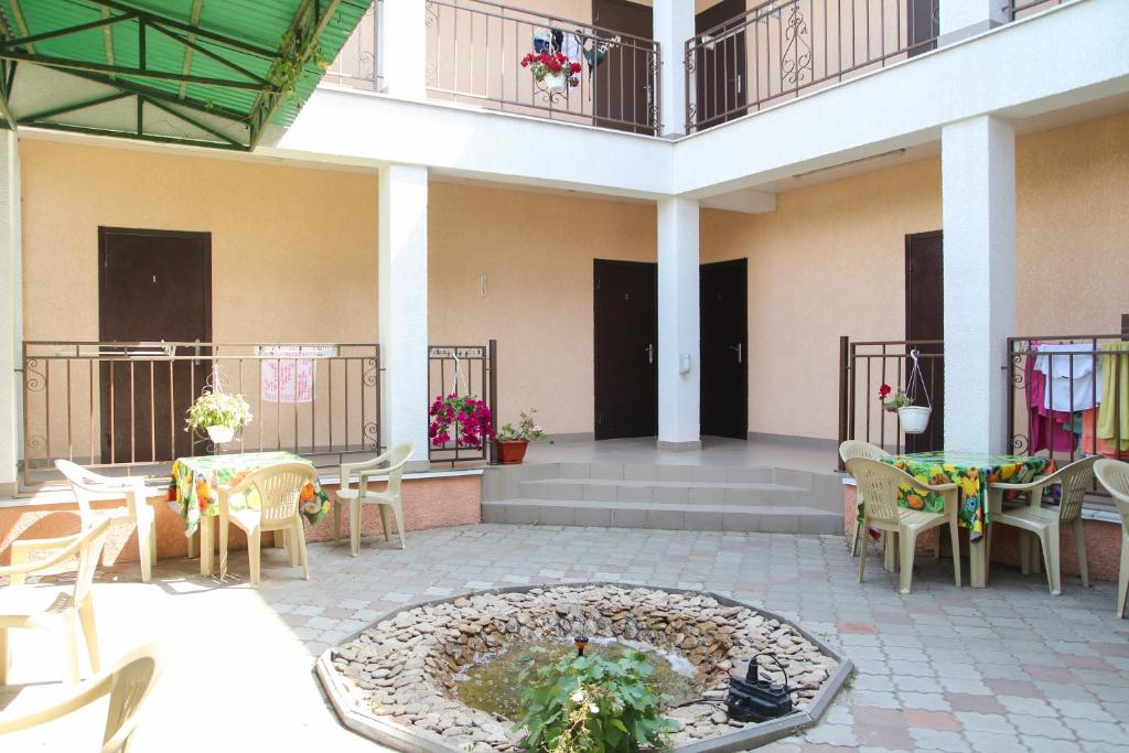 a courtyard with tables and chairs and a fountain at Hotel Kings Zatoka in Zatoka