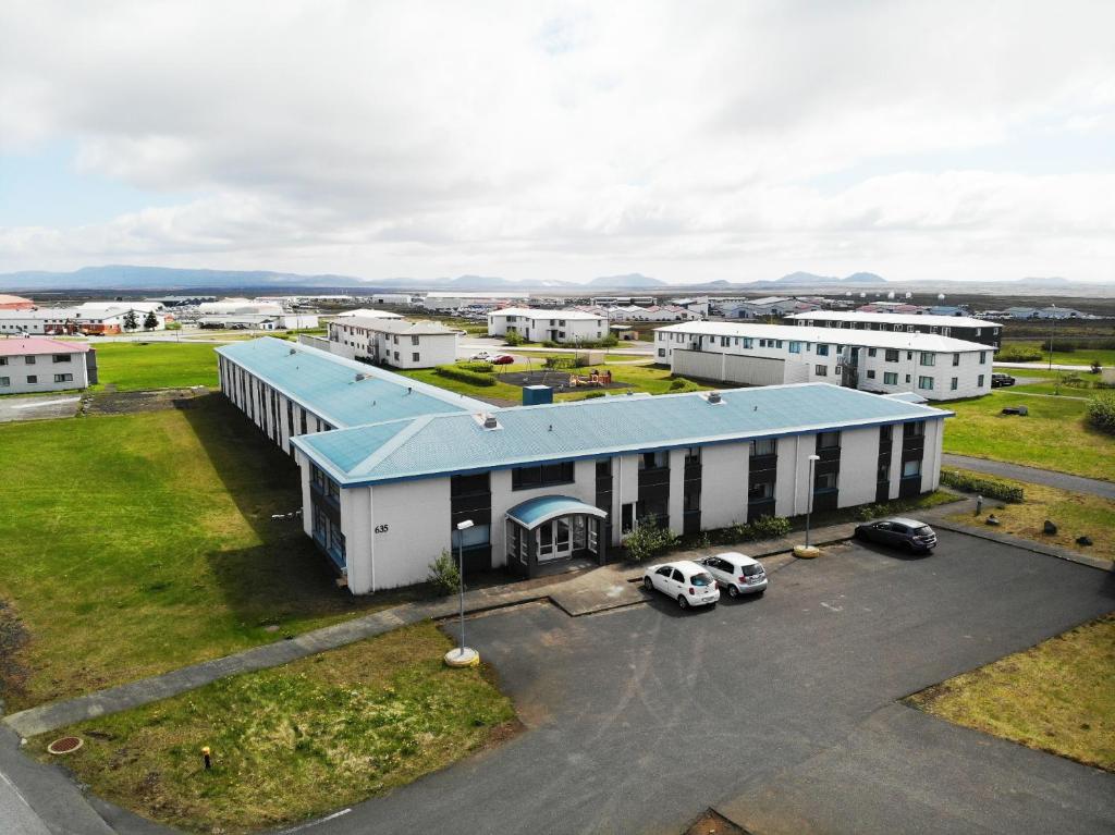 an aerial view of a large white building with a blue roof at Vanny's Guesthouse in Ytri-Njarðvík