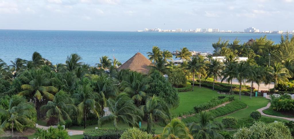 an aerial view of a resort with palm trees and the ocean at Cancun Amara in Cancún