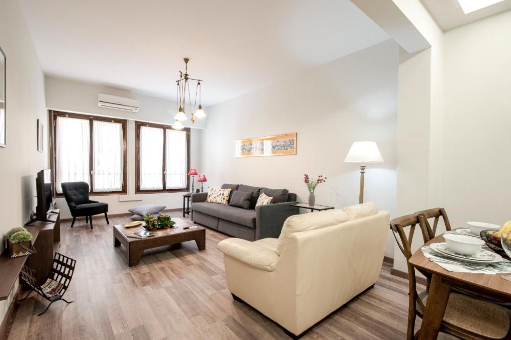 a living room with a couch and a table at ¨Socrates¨ Traditional Apartment In The Center Of Athens in Athens