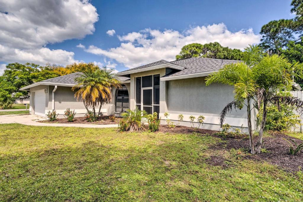 a house with palm trees in a yard at Venice Home with Lanai and Yard about 4 Mi to Beaches in Venice