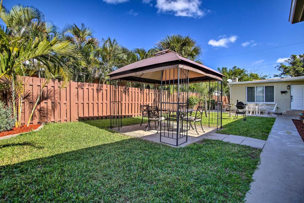 a gazebo with a table and chairs in a yard at Ideally Located Abode with Gazebo in Pompano Beach! in Pompano Beach