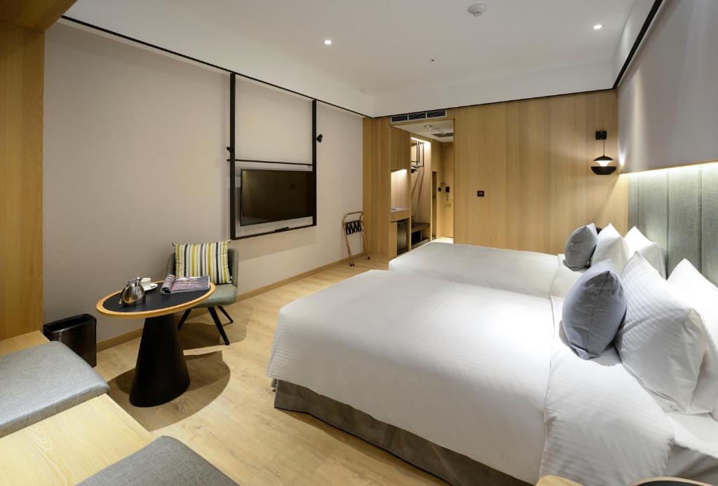 Postel nebo postele na pokoji v ubytování Evergreen Palace Hotel Chiayi