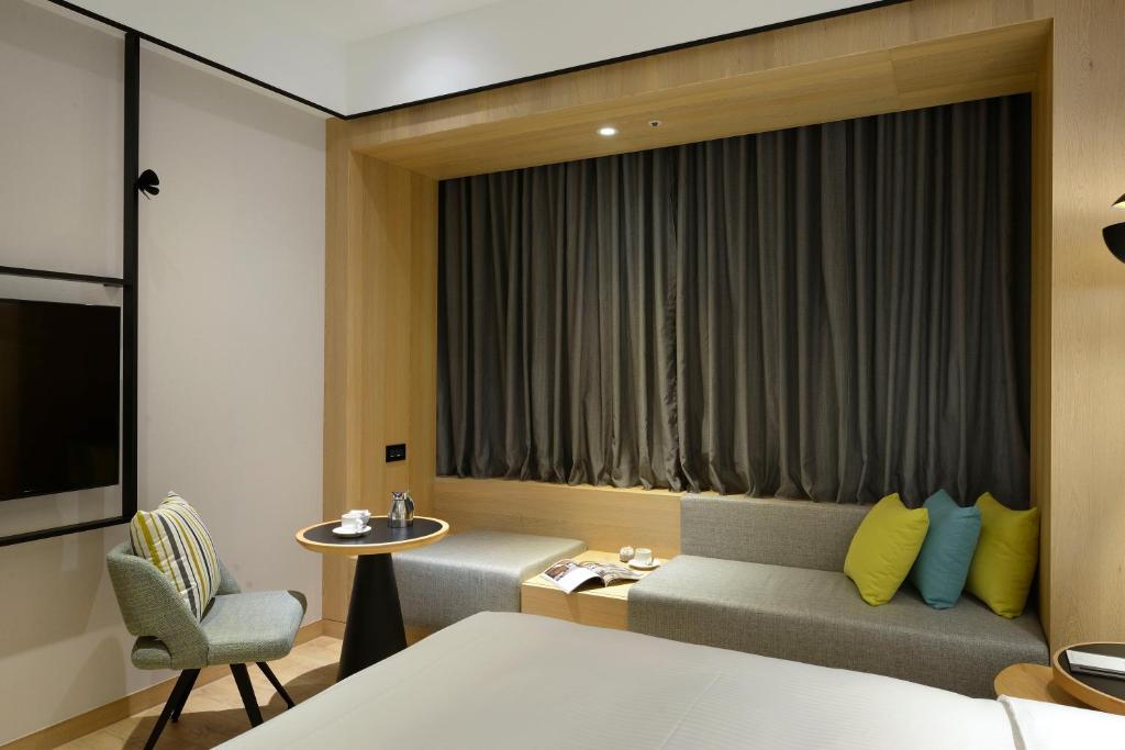Postel nebo postele na pokoji v ubytování Evergreen Palace Hotel Chiayi