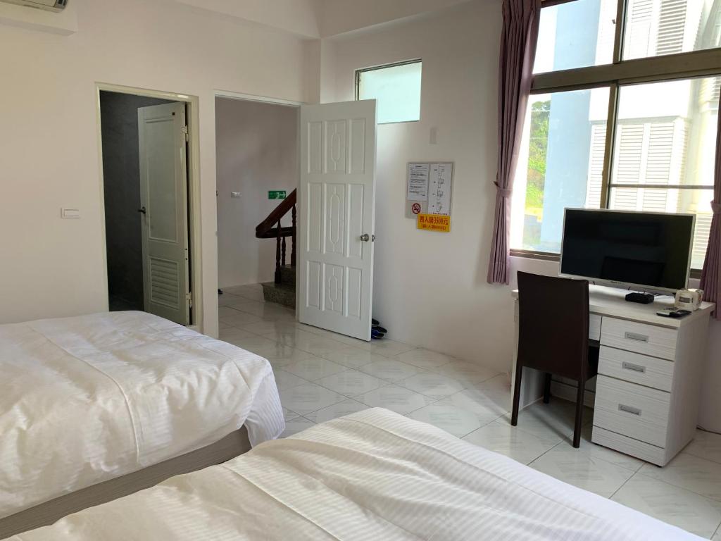 Postel nebo postele na pokoji v ubytování Jin Ji Homestay