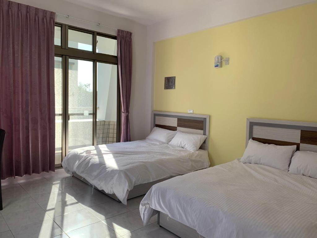 Postel nebo postele na pokoji v ubytování Jin Ji Homestay