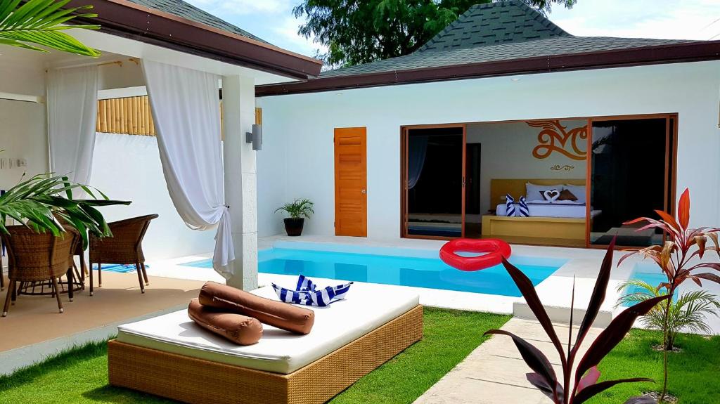 a villa with a pool and a bedroom at Montecarlo Villas Panglao in Panglao Island