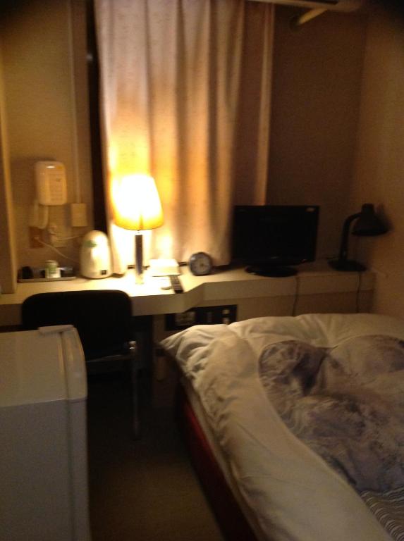 Postel nebo postele na pokoji v ubytování Jyonai Hotel