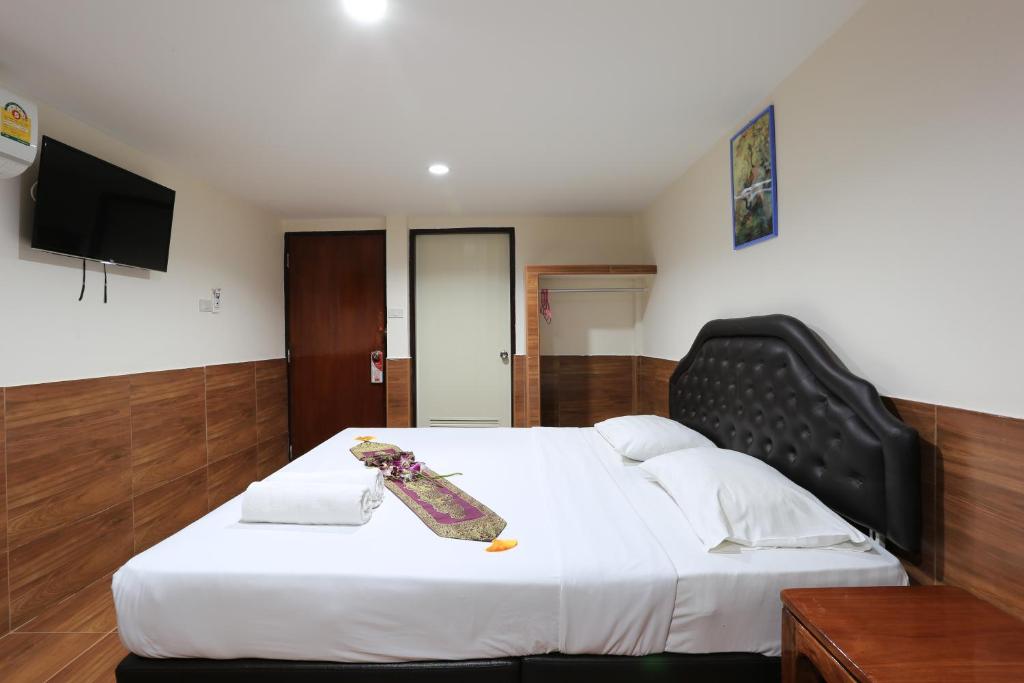 Postel nebo postele na pokoji v ubytování The Siam Guest House - SHA Extra Plus