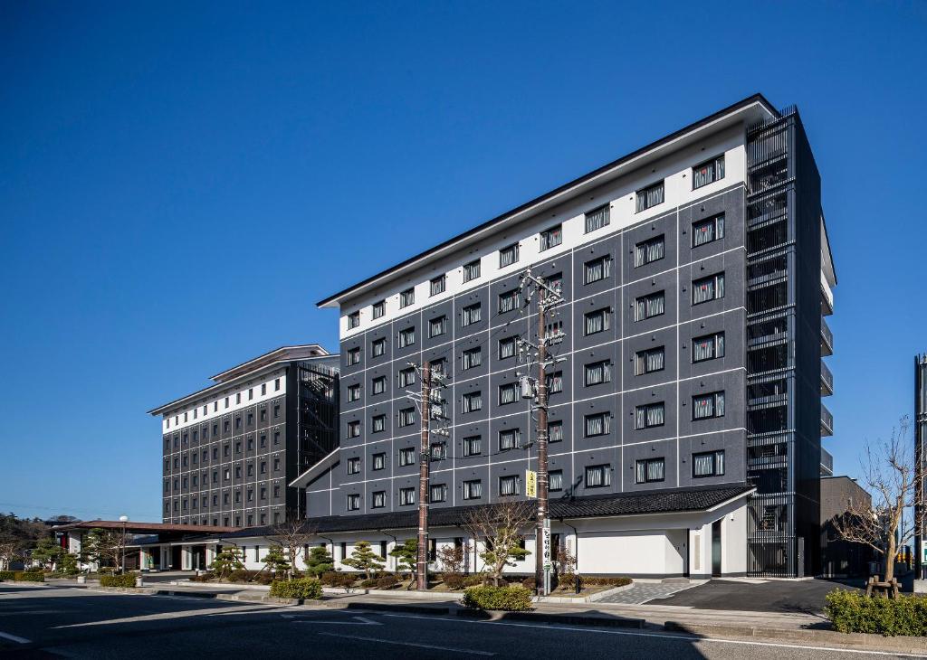 a large black building on a city street at Hotel Route-Inn Wajima in Wajima