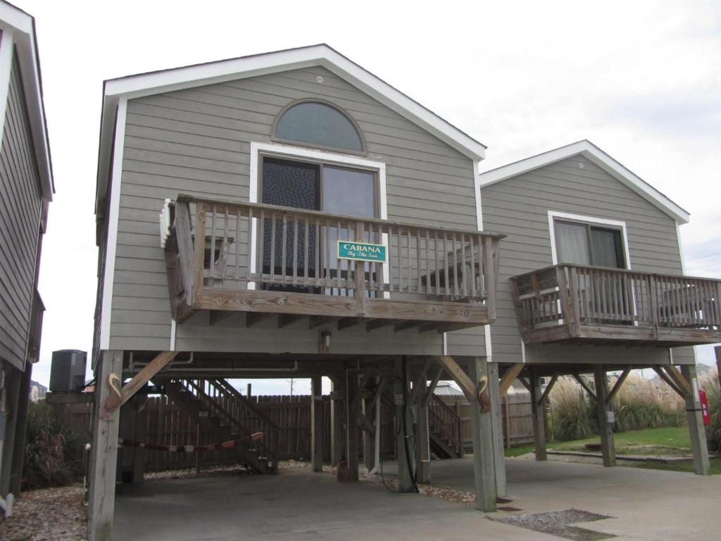 a house with two decks on the front of it at 2 Cabana By The Sea Condo in Hatteras