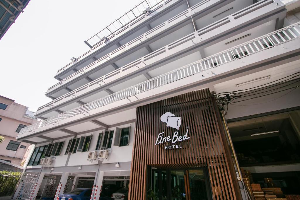 a white building with a elephant sign on it at Fine Bed Hotel in Nonthaburi