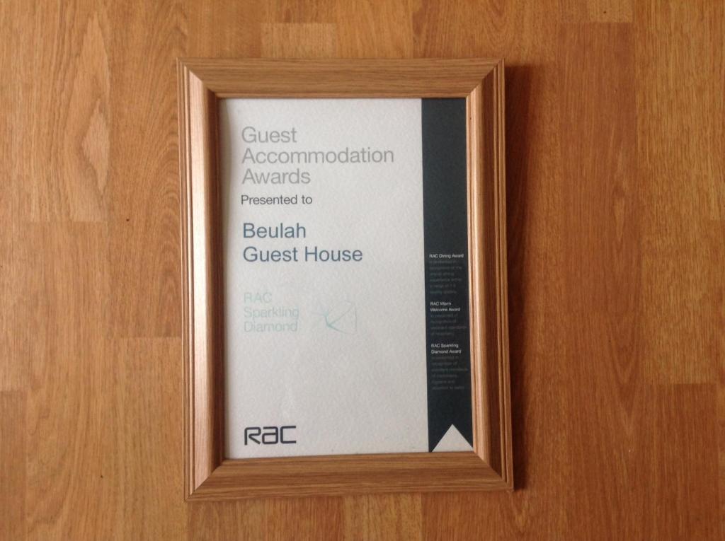 a sign on the door of a guest room at Beulah Guest House in Portrush