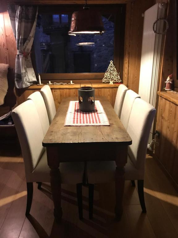 a table with chairs and a candle on top of it at house of hearts - CIR10 in La Thuile