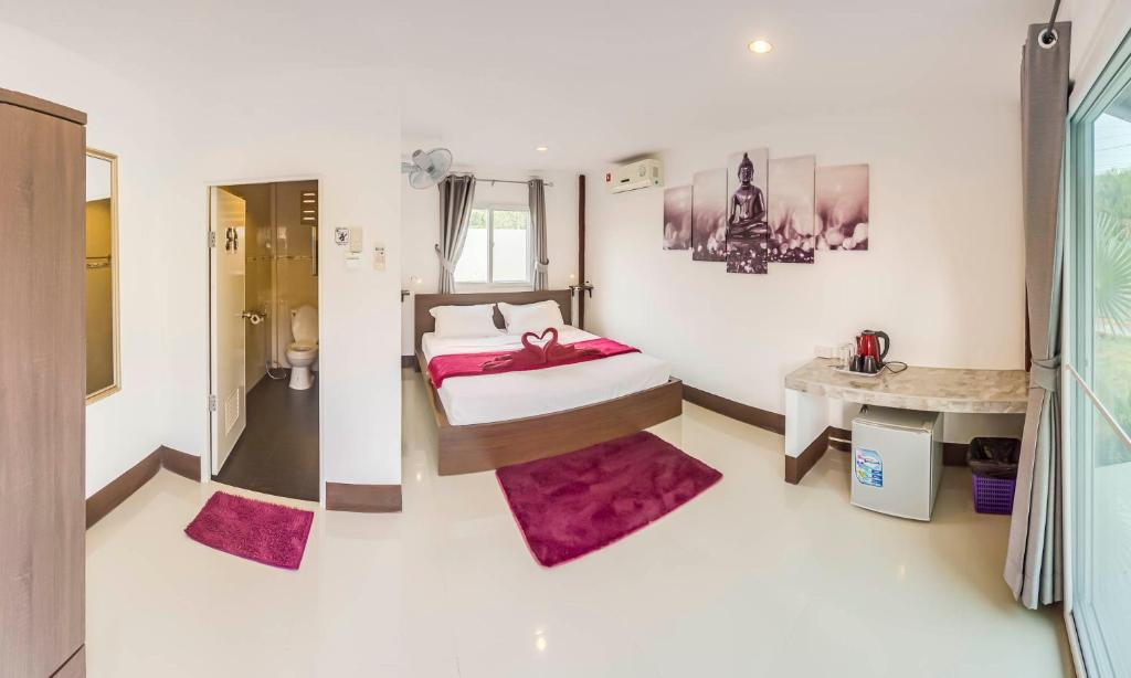 a bedroom with a bed and a shower in it at The Travelers Friend in Ko Lanta