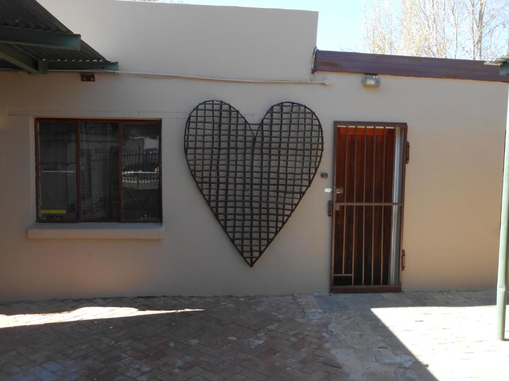 a heart on the side of a building with a door at Wilreco self carting 2 bedroom flat. in Bloemfontein