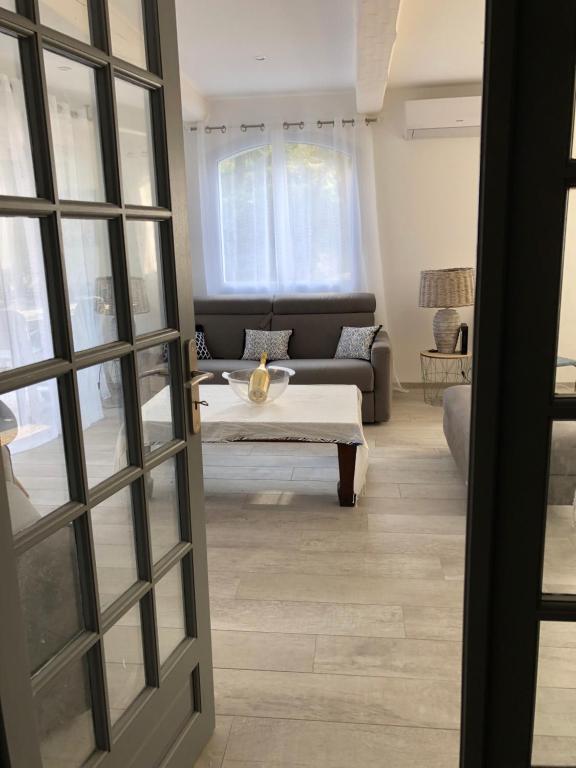 a living room with a couch and a table at Maxima Sunset in Sainte-Maxime