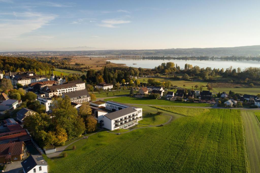 an aerial view of a small town with a lake at Hotel St Elisabeth in Allensbach