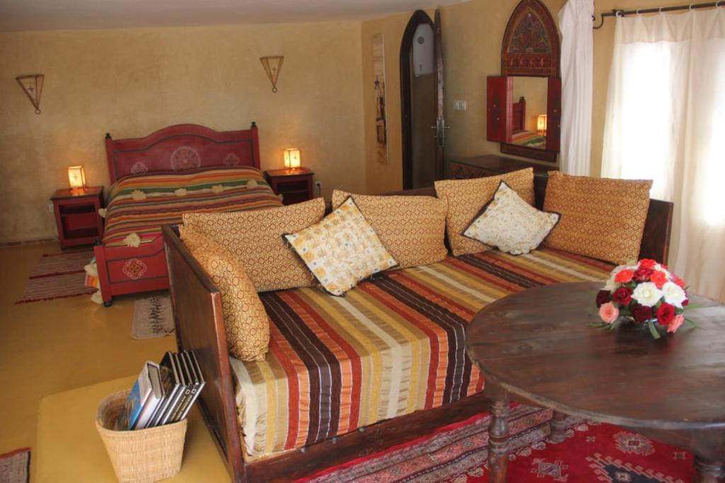 a living room with a couch and a bed at Riad Haizea Mogador in Essaouira