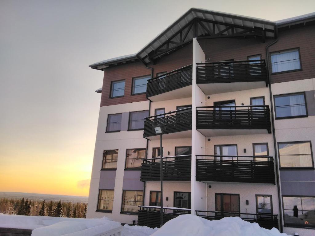 an apartment building with snow in front of it at Ylläs Chalet 8208 in Ylläs