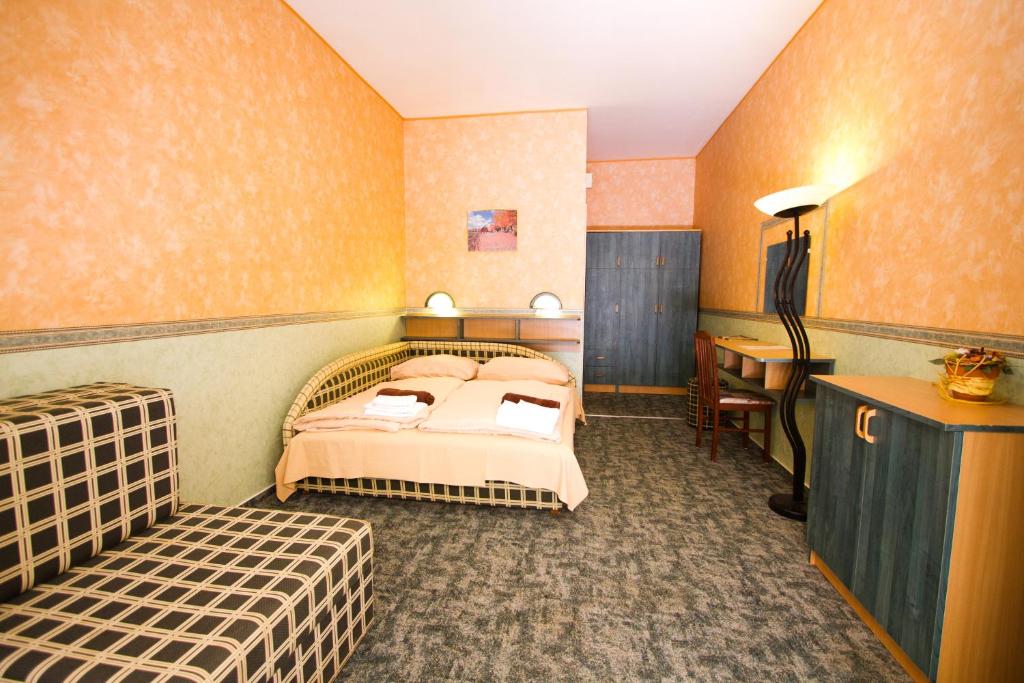 Postel nebo postele na pokoji v ubytování Piknik Wellness Hotel
