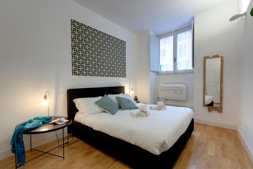 a bedroom with a bed with a table and a mirror at Mamo Florence - Costa San Giorgio Apartment in Florence