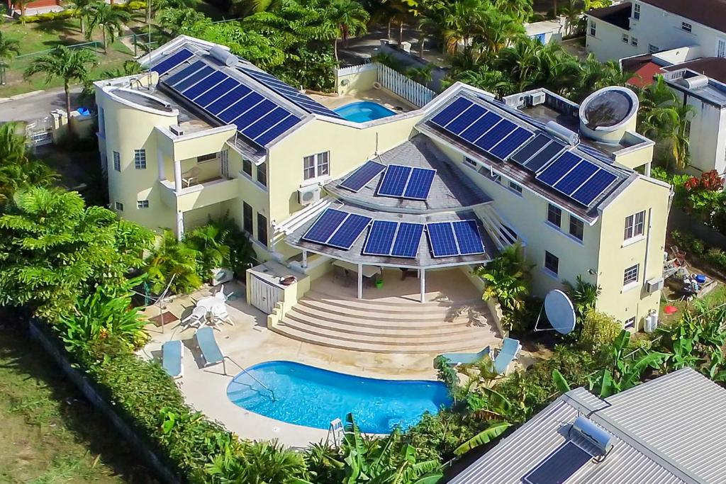 an aerial view of a house with solar panels on it at Vida Mejor - West Pool in Saint James