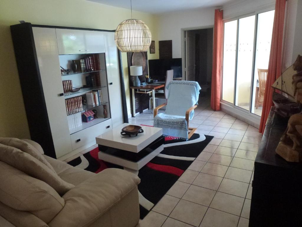 a living room with a couch and a table at Central Montgaillard in Saint-Denis