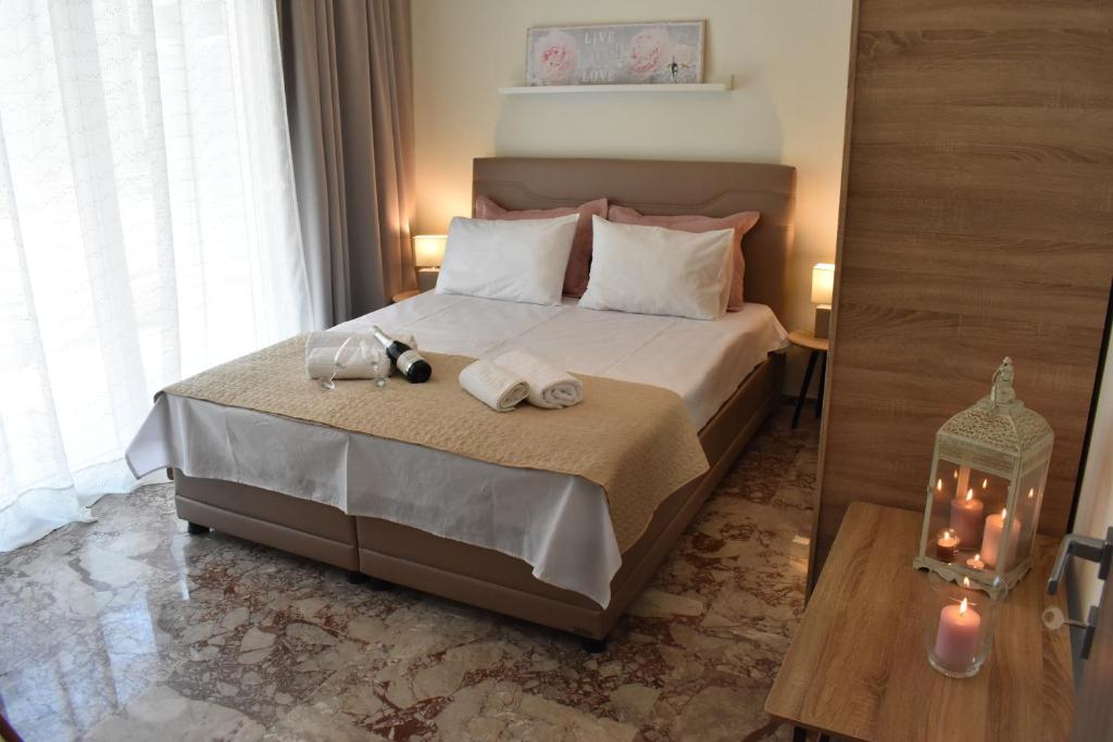 a bedroom with a bed with two towels on it at Chrysafenia & Leandros Downtown in Kavála