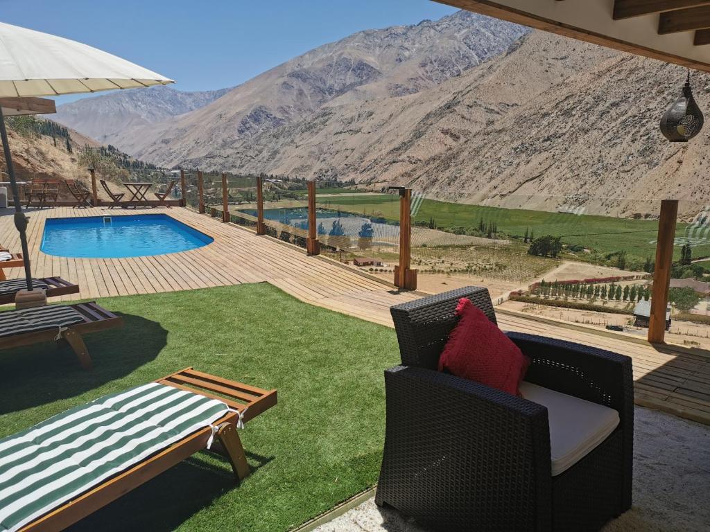 a patio with a view of a pool and mountains at Lodge Nueva Elqui in Pisco Elqui