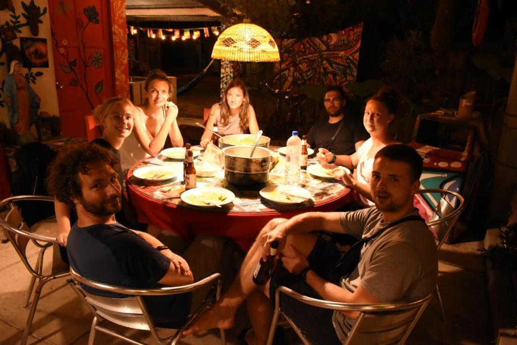 a group of people sitting around a table at Hostal La Casa de Juan in Valle de Anton