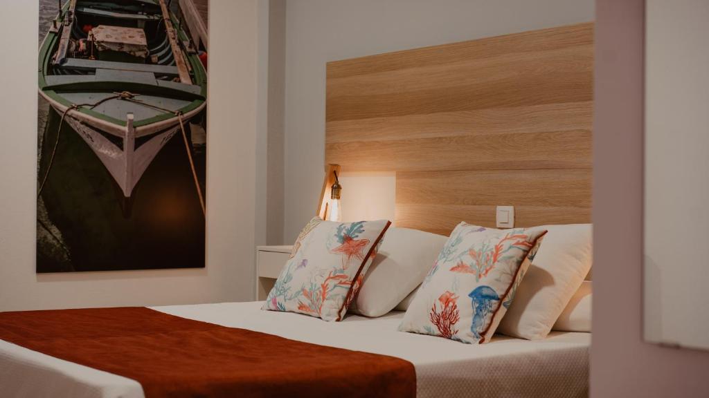 a hotel room with a bed with two pillows at La Pardela Experience Apartamentos in Caleta de Sebo