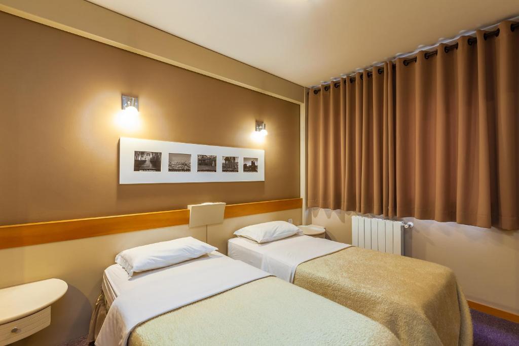 Postel nebo postele na pokoji v ubytování Tri Hotel & Flat Caxias