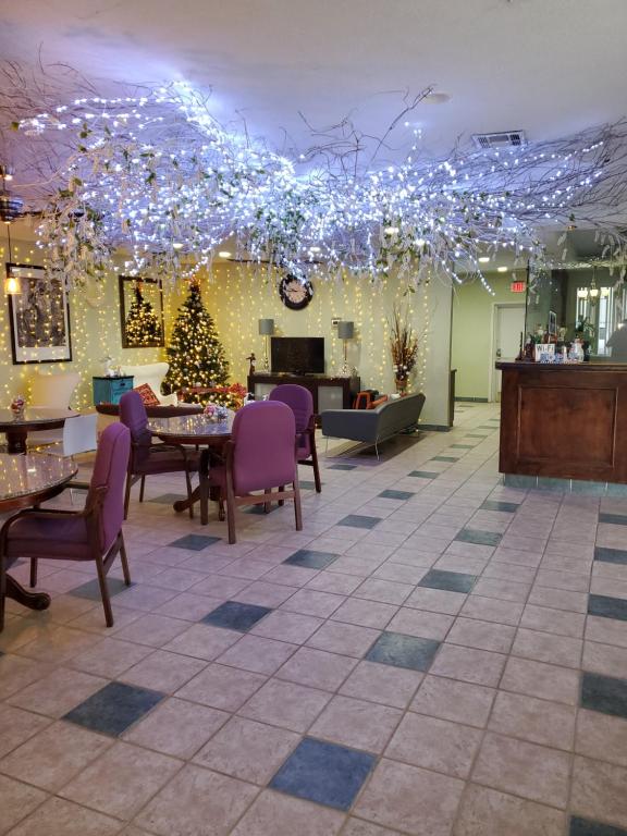 a restaurant with christmas lights and tables and chairs at Houston Inn and Suites in Houston