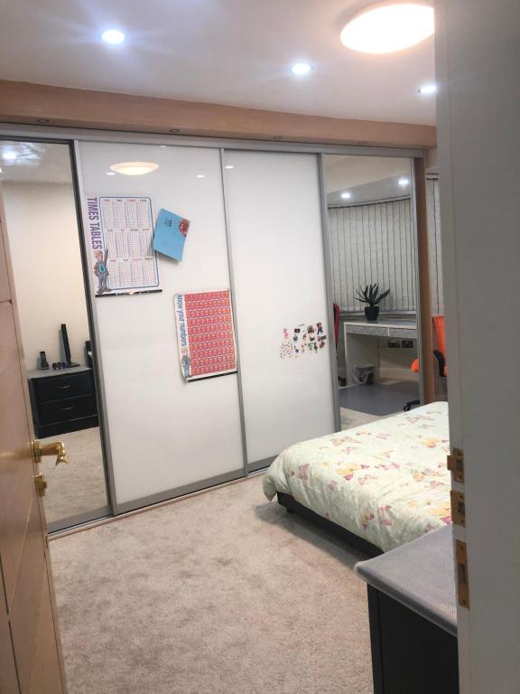 a bedroom with sliding glass doors and a bed at Lyndon B&B in Birmingham