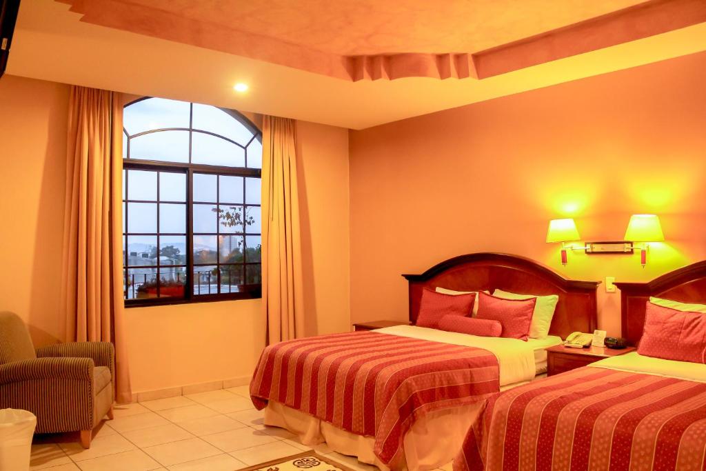 Cama o camas de una habitación en Hotel Monteolivos
