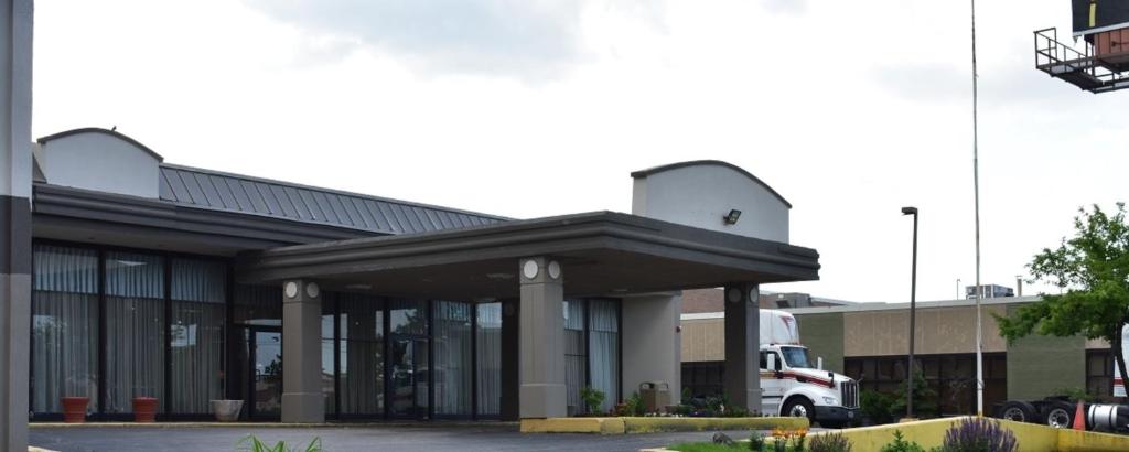 a building with a truck parked in front of it at FairBridge Inn Express Melrose Park in Melrose Park