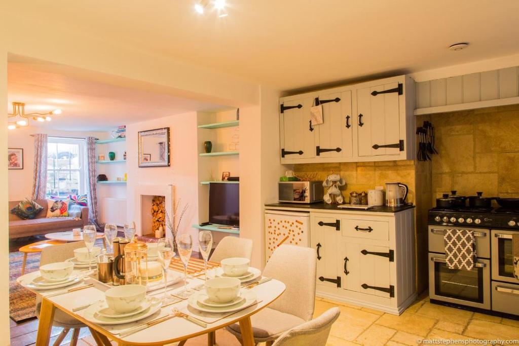 a kitchen with a table and chairs in a room at Seafront Apartment with Garden in Brighton & Hove
