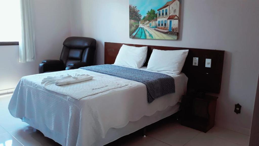 Postel nebo postele na pokoji v ubytování Jacarandá Palace Hotel