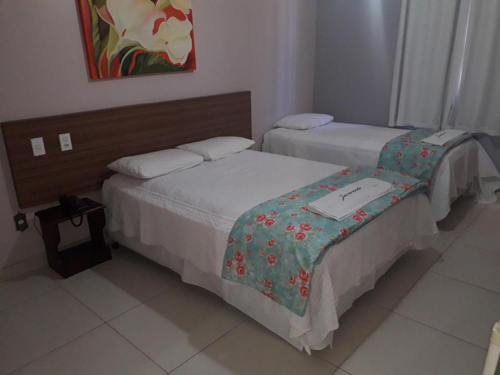 Postel nebo postele na pokoji v ubytování Jacarandá Palace Hotel