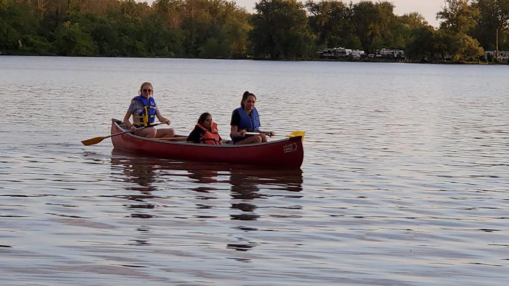 a group of three women in a boat on a lake at Riverview Motel in Dunnville