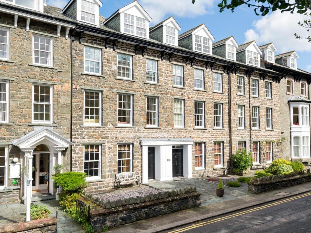 a large brick building with white windows at Chaucer Apartment in Keswick