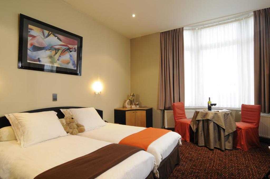 Postel nebo postele na pokoji v ubytování Hotel Grupello