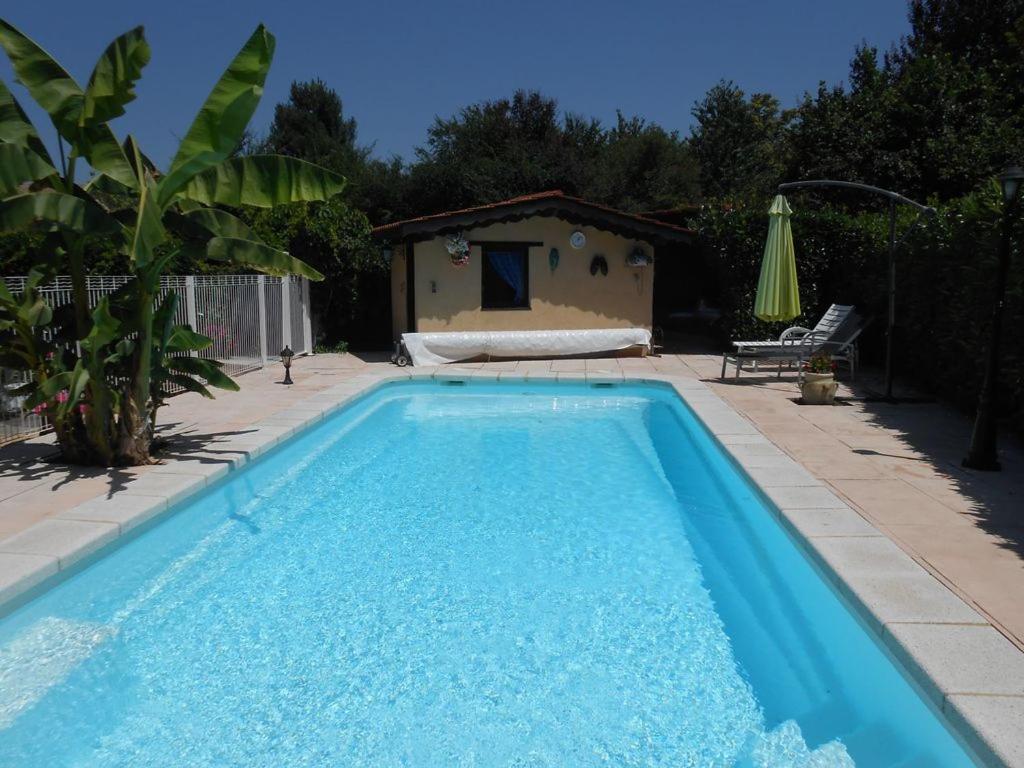 a swimming pool in a yard with a house at Villa NORICA in Bordezac